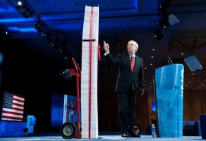 Mitch McConnell Standing Next To A Facsimile Of Obamacare In Print Form